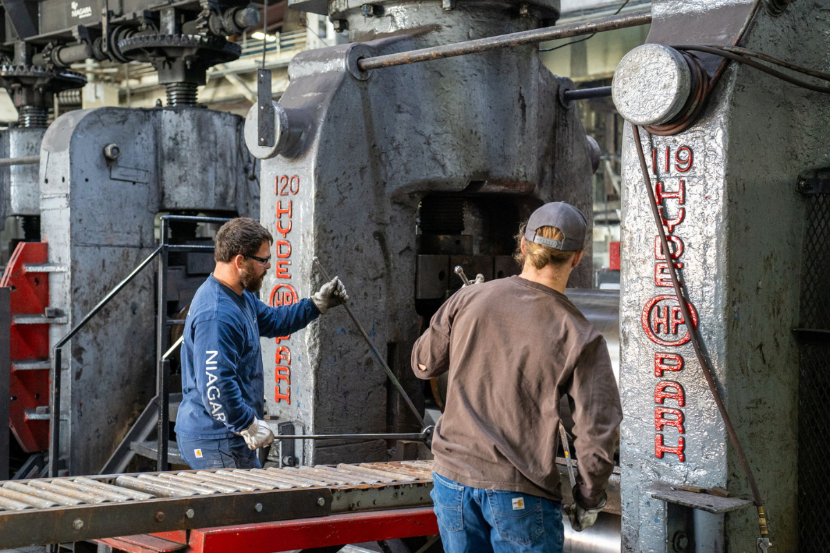 Niagara Specialty Metals employees operating the Hyde Park press in the plate mill, demonstraing the ESOP advantage of employee ownership and shared accountability