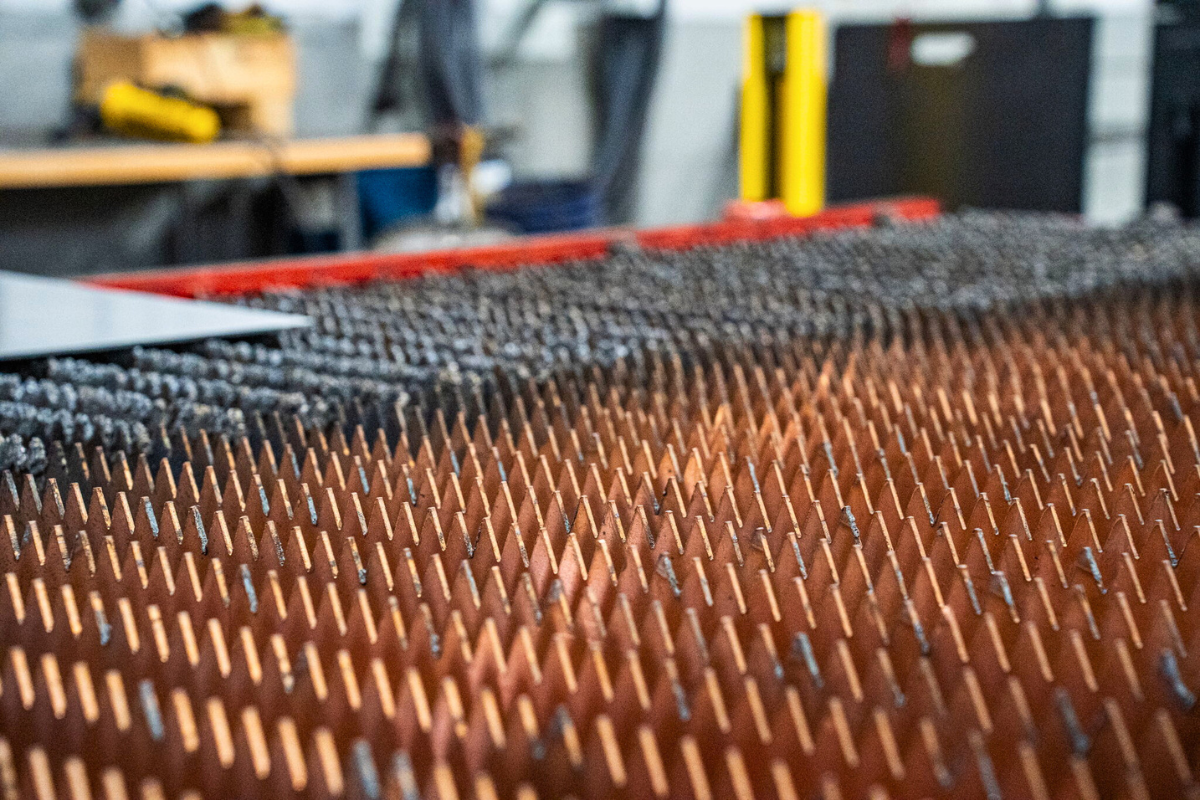 Close-up of laser cutting head blades at Niagara Specialty Metals supporting Erasteel knife steel innovation and precision processing