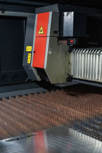Laser machine at Niagara Specialty Metals supporting entrepreneurship in the knife industry through precision steel cutting and innovation