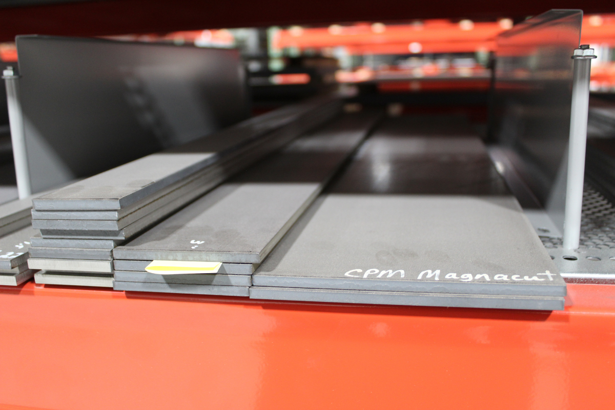 Close-up of MagnaCut knife steel finished goods in multiple sizes at Niagara Specialty Metals warehouse ready for blade manufacturing