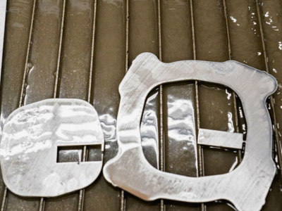 Water jet cut steel pieces at Niagara Specialty Metals demonstrating knife steel dependability and precision processing