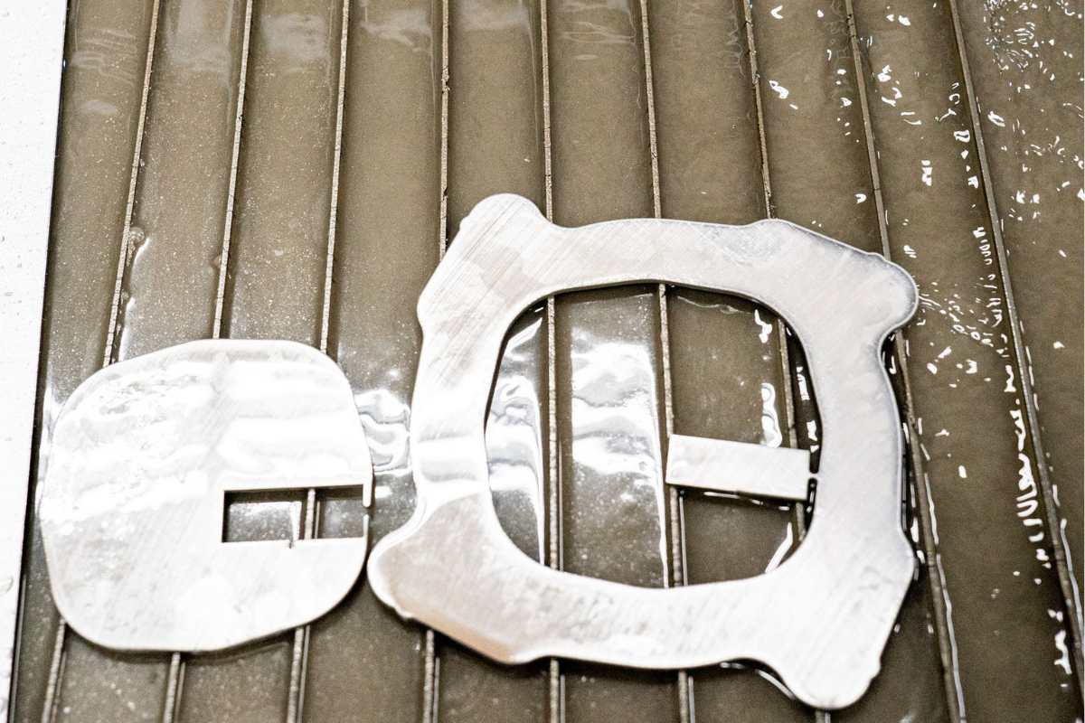 Water jet cut steel pieces at Niagara Specialty Metals demonstrating knife steel dependability and precision processing