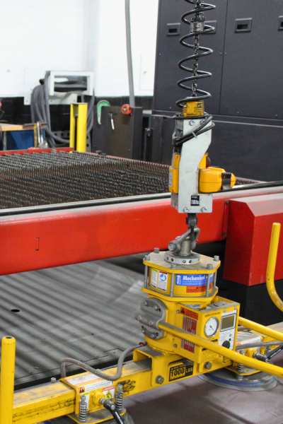 Robot operating near a laser machine at Niagara Specialty Metals highlighting advanced automation by a trusted knife steel supplier