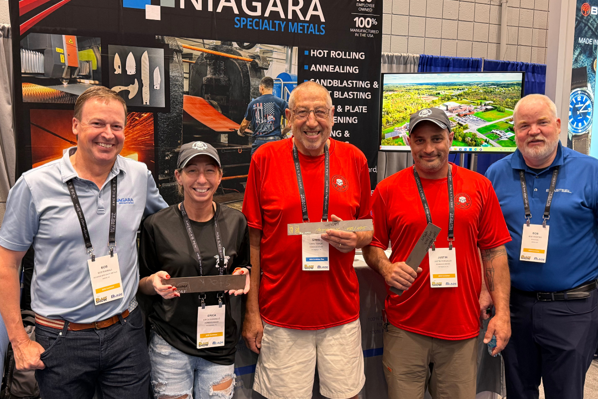 Blade Show Atlanta 2026 raffle winners holding MagnaMax sample material at the Niagara Specialty Metals booth