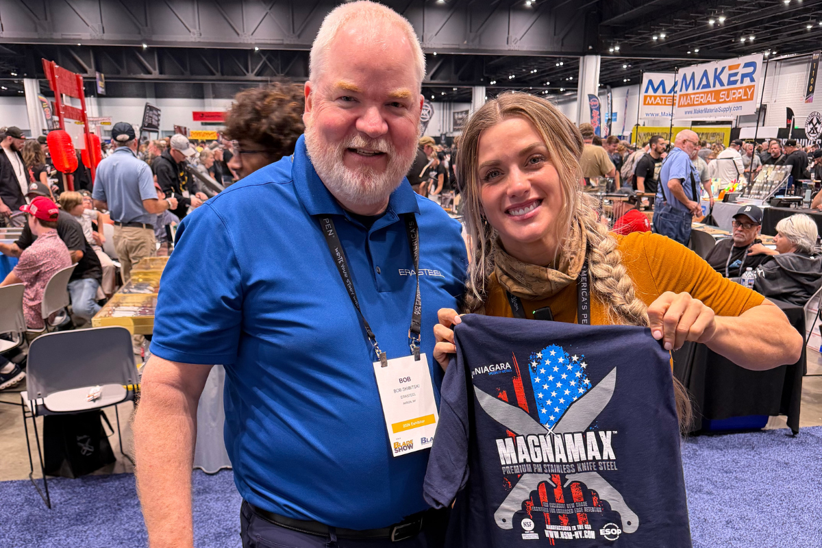 Bob Skibitski and Melissa Backwoods holding a Niagara Specialty Metals MagnaMax t-shirt at Blade Show Atlanta 2026