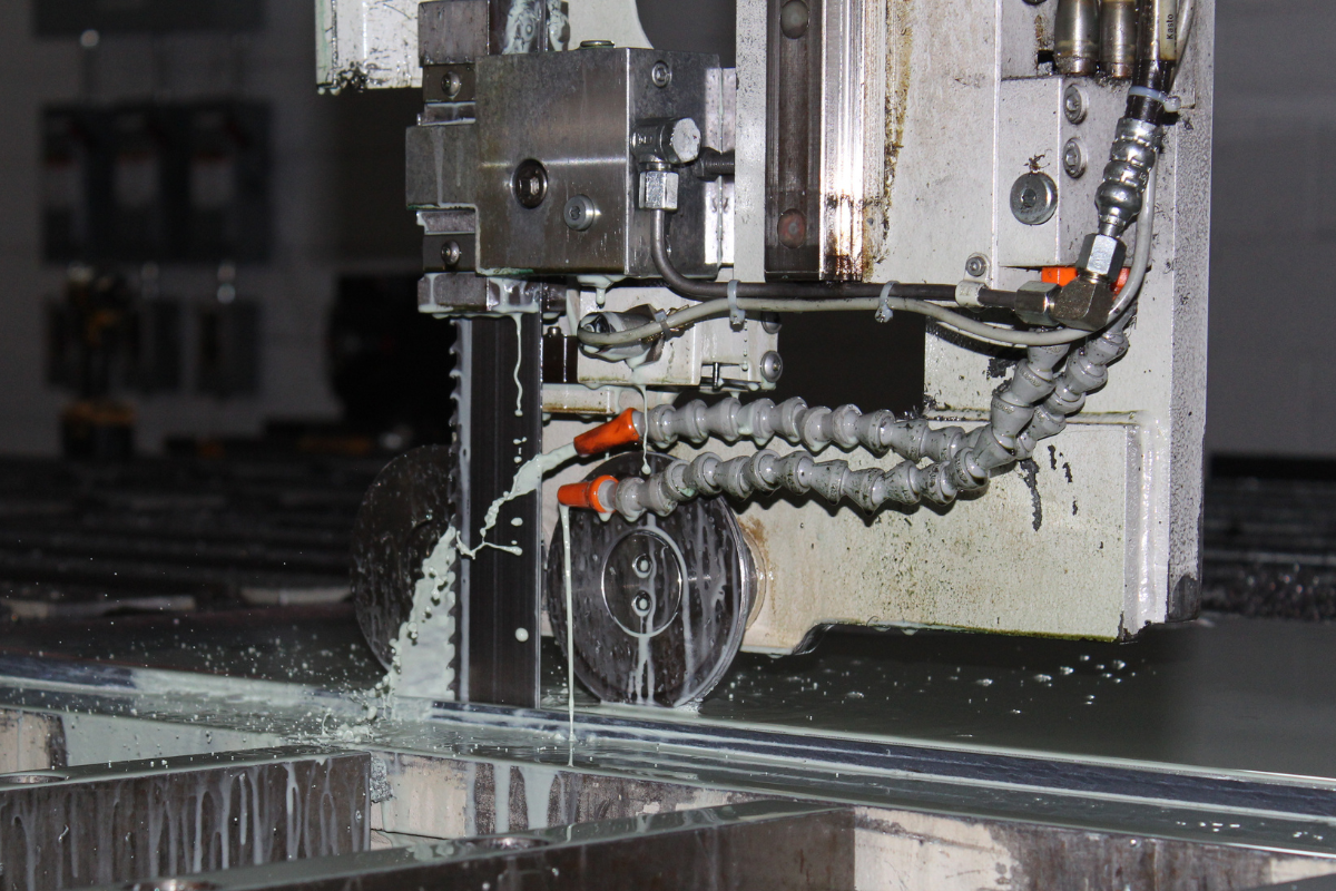 Vertical saw cutting specialty knife steel sheet at Niagara Specialty Metals, supporting precision processing and modern knife steel production.
