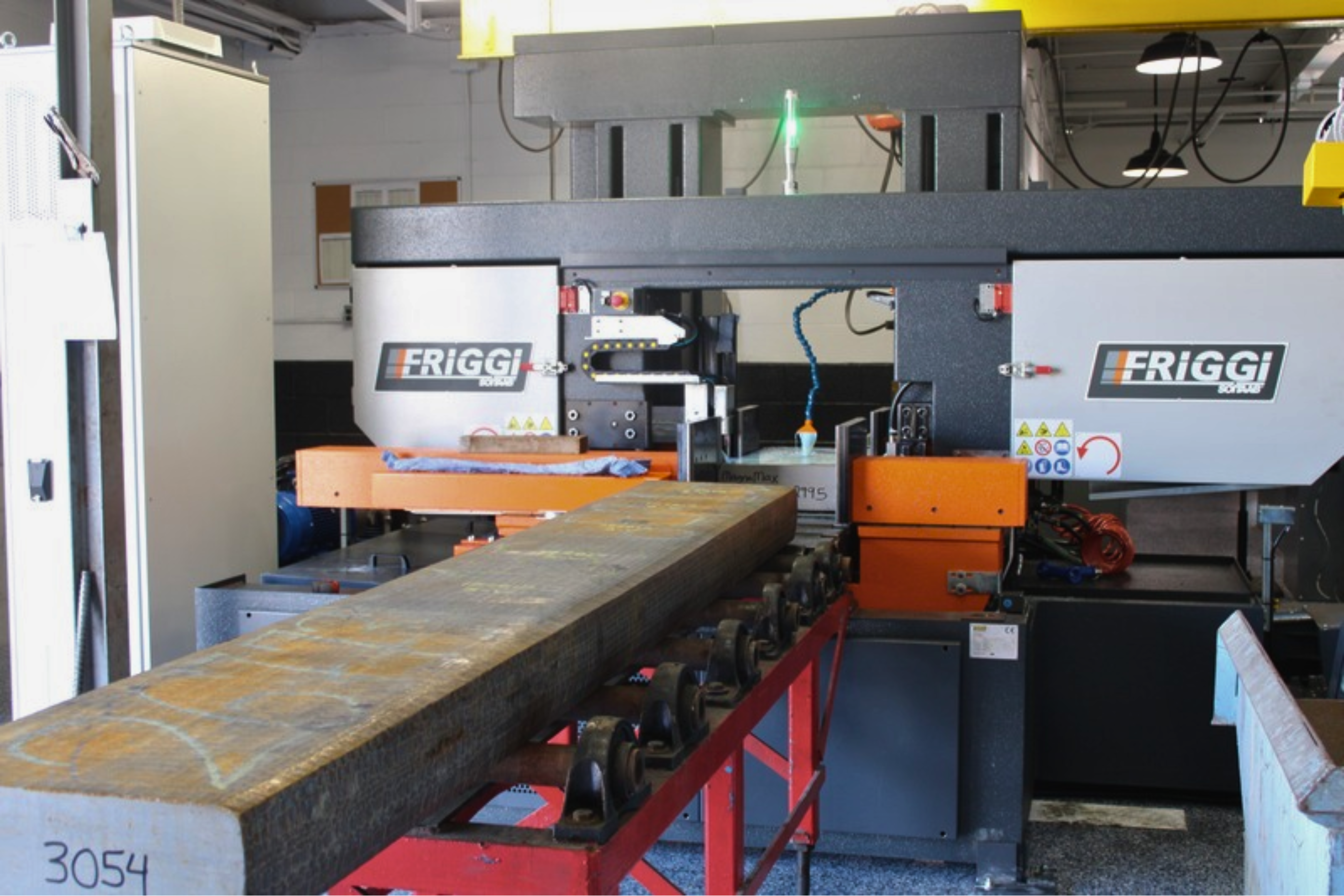 Billet saw cutting at Niagara Specialty Metals with a specialty metal billet positioned on the saw before hot rolling