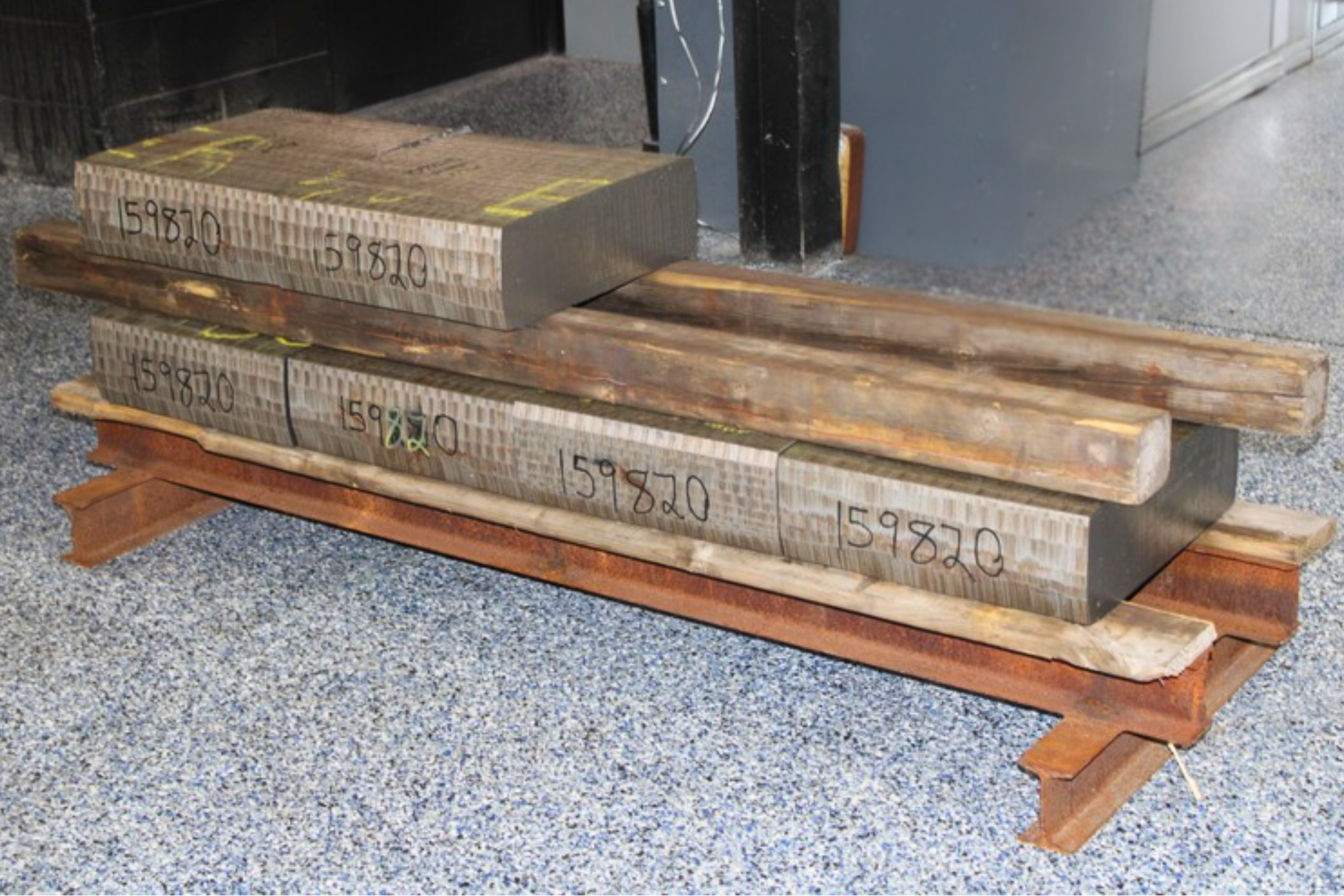 Billet saw cutting at Niagara Specialty Metals with finished cut billets stacked and ready for the next required operation