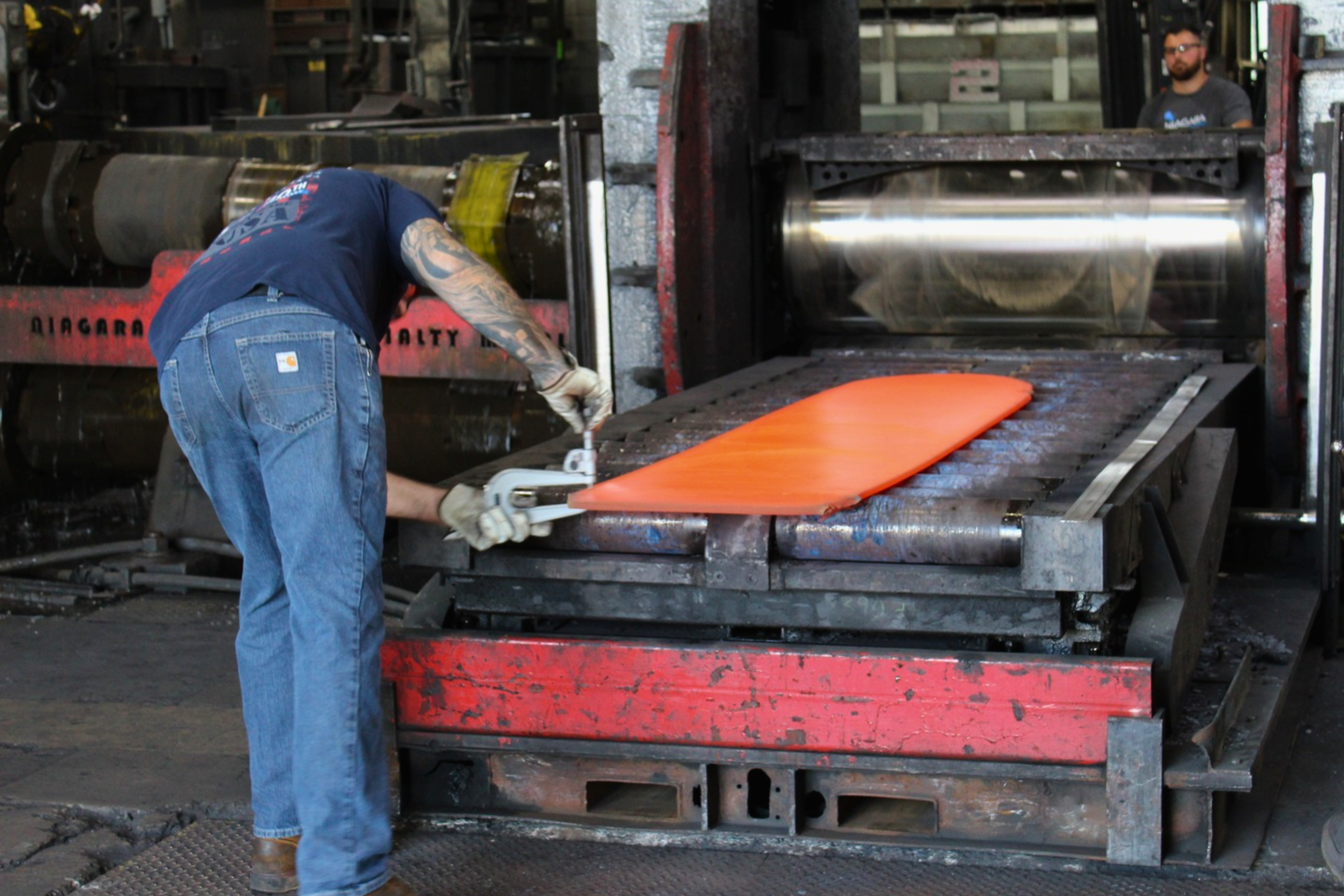 Hot rolling process at Niagara Specialty Metals with plate mill operators monitoring heated specialty metal during rolling